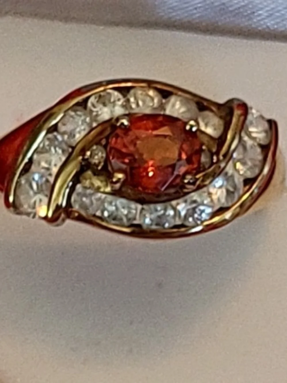1.25ct. Spessartite Garnet Surrounded By 14 Sparkling Diamonds!